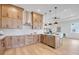 Stylish kitchen with light wood cabinets, stainless steel appliances, and a white backsplash at 3431 Palometa Dr, Hernando Beach, FL 34607