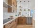 Modern kitchen with light wood cabinets, stainless steel appliances, and an island at 3431 Palometa Dr, Hernando Beach, FL 34607