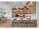 Modern kitchen with light wood cabinets, stainless steel appliances, and an island with seating at 3431 Palometa Dr, Hernando Beach, FL 34607