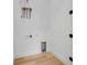 Bright laundry room with white walls and wood floors at 3431 Palometa Dr, Hernando Beach, FL 34607