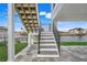 Modern stairs leading down to the patio and canal at 3431 Palometa Dr, Hernando Beach, FL 34607