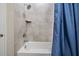 Bathroom with tub and shower and blue curtain at 34432 Wynthorne Pl, Wesley Chapel, FL 33545