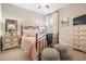 Bedroom with metal bed frame and neutral colored bedding at 34432 Wynthorne Pl, Wesley Chapel, FL 33545