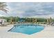 Inviting community pool with lounge chairs and patio tables at 34432 Wynthorne Pl, Wesley Chapel, FL 33545