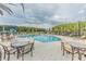 Relaxing community pool with patio tables and lounge chairs at 34432 Wynthorne Pl, Wesley Chapel, FL 33545