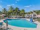 Inviting community pool with lounge chairs and palm trees at 34432 Wynthorne Pl, Wesley Chapel, FL 33545