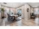 Elegant dining room with a large table, chandelier, and access to a patio at 34432 Wynthorne Pl, Wesley Chapel, FL 33545
