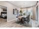 Bright dining room with a wooden table and chairs, offering a view to a bedroom at 34432 Wynthorne Pl, Wesley Chapel, FL 33545