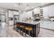 Modern kitchen with white cabinets, a large island, and stainless steel appliances at 34432 Wynthorne Pl, Wesley Chapel, FL 33545