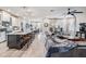 Open concept living space featuring a kitchen island and spacious leather sectional sofa at 34432 Wynthorne Pl, Wesley Chapel, FL 33545
