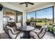 Relaxing screened patio with outdoor furniture and a grill at 34432 Wynthorne Pl, Wesley Chapel, FL 33545