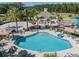 Community pool with lounge chairs and umbrellas at 34432 Wynthorne Pl, Wesley Chapel, FL 33545