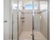 Large walk-in shower with glass doors and tile surround at 34432 Wynthorne Pl, Wesley Chapel, FL 33545