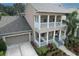 Two-story house with a large yard, driveway and neutral color scheme at 406 Manns Harbor Dr, Apollo Beach, FL 33572