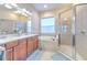 Spa-like bathroom featuring double sinks, a large tub, and a shower at 406 Manns Harbor Dr, Apollo Beach, FL 33572