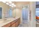 Double vanity bathroom with a shower and tub at 406 Manns Harbor Dr, Apollo Beach, FL 33572