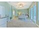 Primary bedroom with light green walls, ceiling fan, and access to backyard at 406 Manns Harbor Dr, Apollo Beach, FL 33572