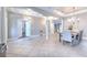 Elegant dining room features a large table, chandelier, and tile floors at 406 Manns Harbor Dr, Apollo Beach, FL 33572