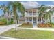 Two-story house with a neutral exterior, a large front porch, and a two-car garage at 406 Manns Harbor Dr, Apollo Beach, FL 33572