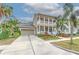 Tan two-story house with white columns, a large front porch, and a two-car garage at 406 Manns Harbor Dr, Apollo Beach, FL 33572