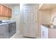 Convenient laundry room with washer, dryer, and utility sink at 406 Manns Harbor Dr, Apollo Beach, FL 33572