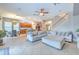 Open concept living room and kitchen with tile floors, island, and neutral decor at 406 Manns Harbor Dr, Apollo Beach, FL 33572