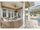 Covered patio with wicker furniture and fire pit at 406 Manns Harbor Dr, Apollo Beach, FL 33572