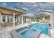 Inviting pool and spa with covered patio and outdoor kitchen at 406 Manns Harbor Dr, Apollo Beach, FL 33572