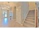 Elegant staircase with wood railing and carpeted steps at 406 Manns Harbor Dr, Apollo Beach, FL 33572