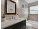 Updated bathroom with tub, toilet and dark vanity at 5084 42Nd S St, St Petersburg, FL 33711