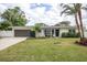 White brick ranch home with a gray garage door and manicured lawn at 5084 42Nd S St, St Petersburg, FL 33711