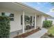 Updated front porch with columns, sitting area, and landscaping at 5084 42Nd S St, St Petersburg, FL 33711