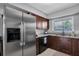 Stainless steel appliances and dark wood cabinets in kitchen at 5084 42Nd S St, St Petersburg, FL 33711