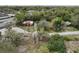 Aerial view of a property with two houses on a wooded lot at 5414 N River Shore Dr, Tampa, FL 33603