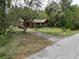Red house with a yard and driveway at 5414 N River Shore Dr, Tampa, FL 33603