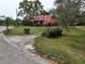 Pink house with a porch and landscaped front yard at 5414 N River Shore Dr, Tampa, FL 33603