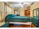 Spacious bedroom with wood floors and a green bed at 5927 3Rd N Ave, St Petersburg, FL 33710