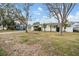 Front view of a white house with a yard and palm trees at 5927 3Rd N Ave, St Petersburg, FL 33710
