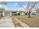 Ranch-style home with a green garage door and spacious yard at 5927 3Rd N Ave, St Petersburg, FL 33710