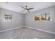 Bedroom with ceiling fan and large window with blinds at 6025 Venetian Ne Blvd, St Petersburg, FL 33703