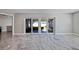 Living area with marble floors and sliding doors to a patio at 6025 Venetian Ne Blvd, St Petersburg, FL 33703