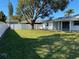 Spacious backyard with large tree and white fence at 6720 35Th N Ter, St Petersburg, FL 33710