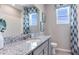 Bathroom with granite countertop, gray cabinets, and a modern sink at 677 157Th E Ct, Bradenton, FL 34212