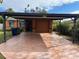 Front view of a single-story house with carport and a paved driveway at 6818 S Himes Ave, Tampa, FL 33611