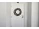White condo front door with a lavender wreath at 7 Elgin Pl # 603, Dunedin, FL 34698