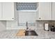 Kitchen features granite countertops and a farmhouse sink at 7 Elgin Pl # 603, Dunedin, FL 34698