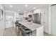 Open concept kitchen with white cabinets and granite countertops at 7 Elgin Pl # 603, Dunedin, FL 34698