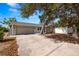 Updated one story home with gray exterior, attached garage, and mature landscaping at 801 54Th S Ave, St Petersburg, FL 33705