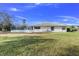 Spacious backyard with grassy lawn and screened enclosure at 8936 Hargrove Dr, Hudson, FL 34667