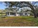 Ranch-style home with screened porch and large backyard at 10308 Forest Hills Dr, Tampa, FL 33612
